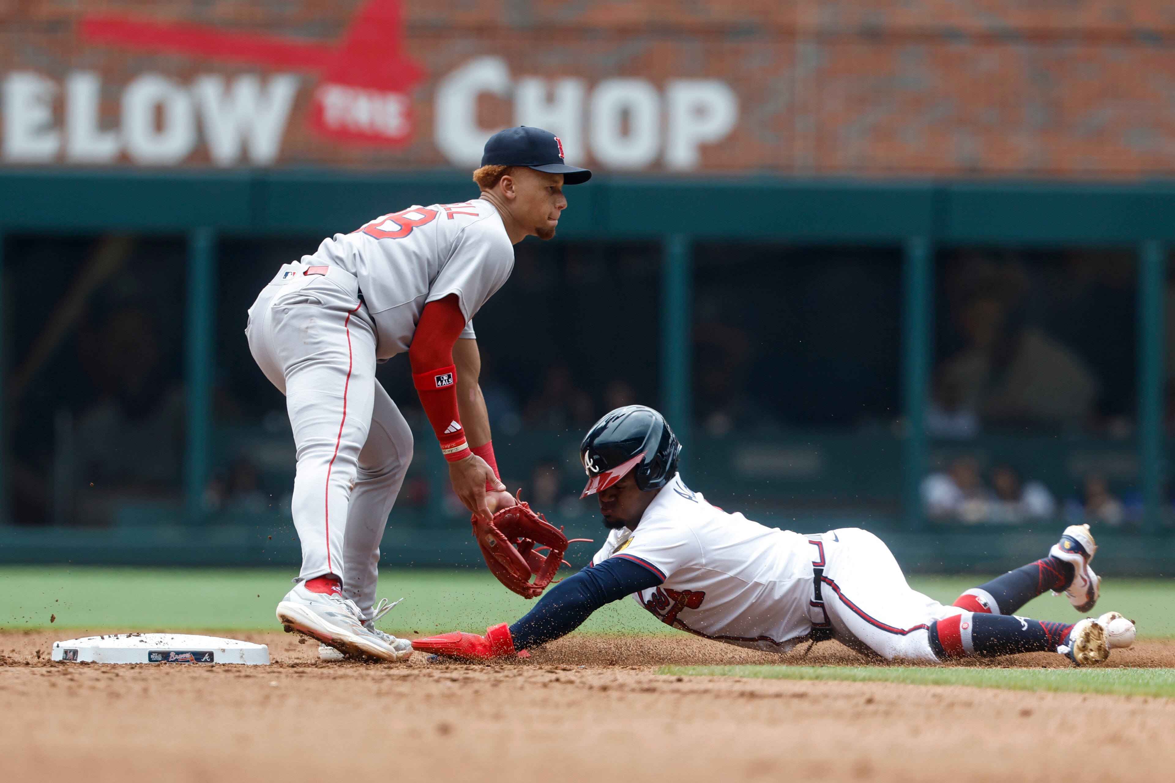 Atlanta Braves' Ozzie Albies (1) is hit by the throw to Boston Red Sox second baseman Kristian Campbell (28) as he safely steals second base during the fourth inning of a baseball game, Sunday, June 1, 2025, in Atlanta. (AP Photo/Butch Dill)