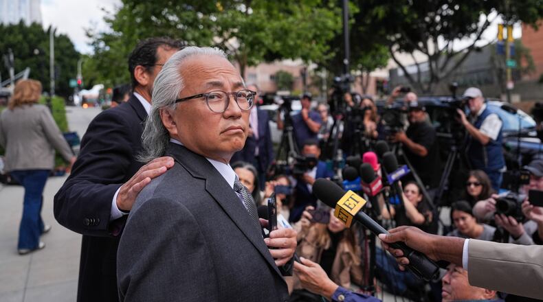 Kenneth Iwamasa, one of five people who pleaded guilty in the ketamine overdose death of actor Matthew Perry, looks away as his attorney, Alan Eisner, talks to reporters after Iwamasa's sentencing in Los Angeles, Wednesday, May 27, 2026. (AP Photo/Jae C. Hong)