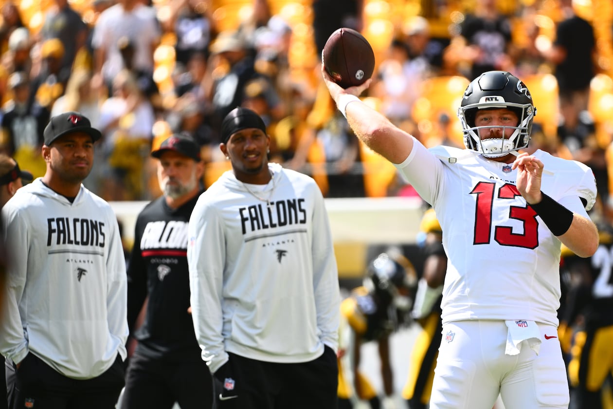 Falcons quarterback Cooper Rush (right) warms up with Falcons quarterbacks Tua Tagovailoa (left) and Michael Penix Jr. (center) behind him before an NFL football game, Sunday, Sept. 13, 2026, in Pittsburgh. (Justin Berl/AP)