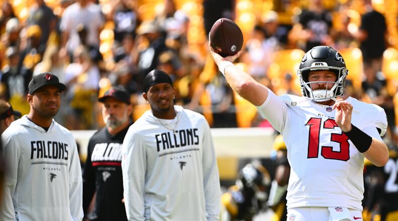 Atlanta Falcons quarterback Cooper Rush (13) warms up with Atlanta Falcons quarterback Tua Tagovailoa (1) and Atlanta Falcons quarterback Michael Penix Jr. (9) behind him before an NFL football game, Sunday, Sept. 13, 2026, in Pittsburgh. (AP Photo/Justin Berl)