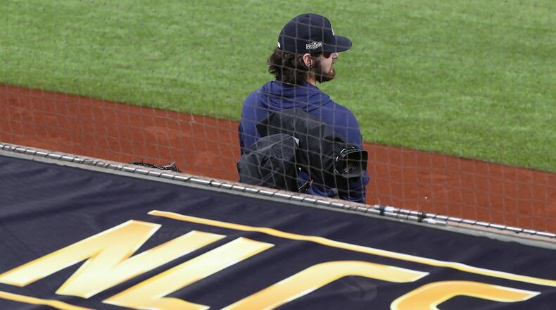 Braves Game 2 starting pitcher Ian Anderson takes in the scene for the National League Championship Series against the Los Angeles Dodgers from the team dugout during workouts Sunday at Globe Life Field in Arlington, Texas. (Curtis Compton / Curtis.Compton@ajc.com)