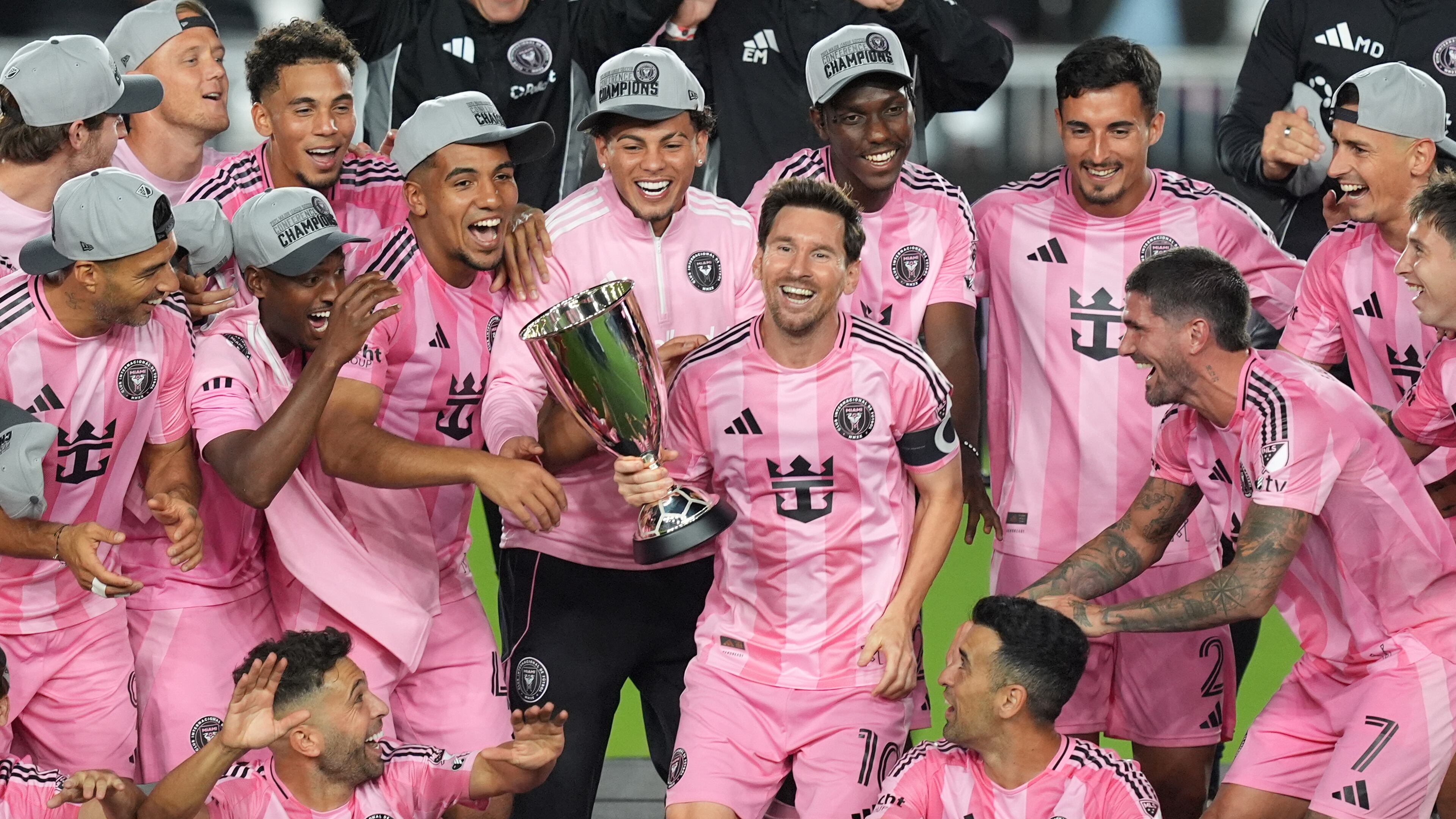 Inter Miami forward Lionel Messi (10) holds the trophy as Inter Miami players celebrate winning an MLS Eastern Conference final soccer match against New York City FC, Saturday, Nov. 29, 2025, in Fort Lauderdale, Fla. (AP Photo/Rebecca Blackwell)