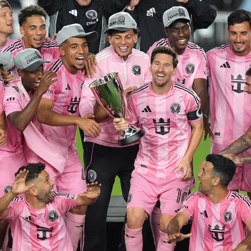 Inter Miami forward Lionel Messi (10) holds the trophy as Inter Miami players celebrate winning an MLS Eastern Conference final soccer match against New York City FC, Saturday, Nov. 29, 2025, in Fort Lauderdale, Fla. (AP Photo/Rebecca Blackwell)