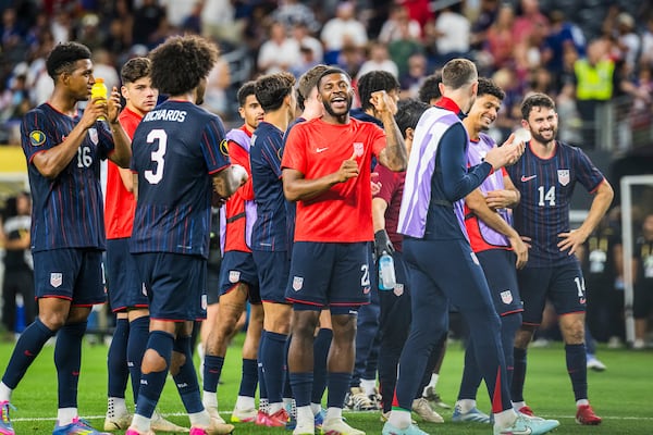 United States defender Mark McKenzie celebrates with teammates after a win over Haiti in a CONCACAF Gold Cup soccer match, Sunday, June 22, 2025, in Arlington, Texas. (AP Photo/Jessica Tobias)