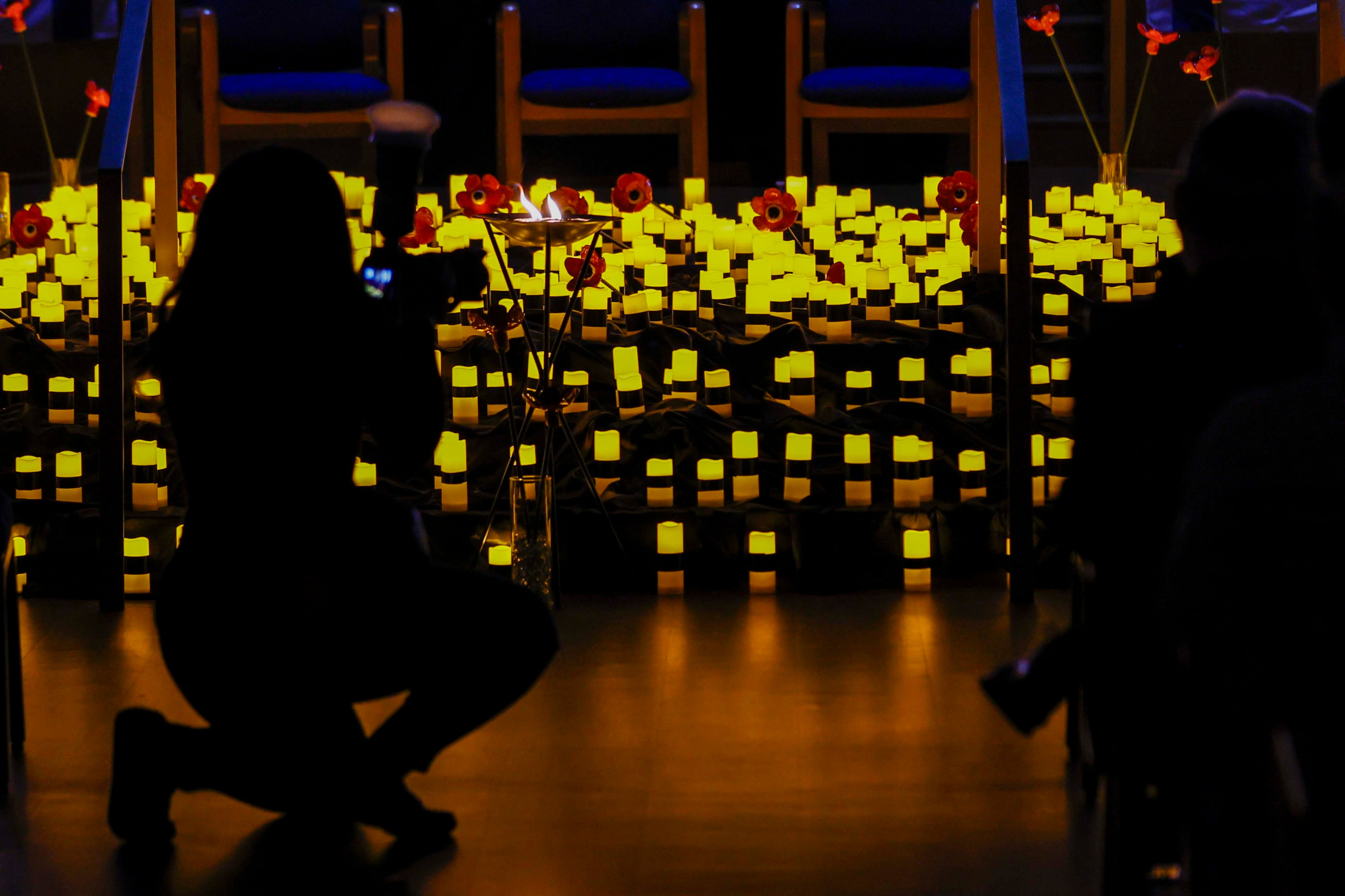 A memorial with candle lights and flowers is seen on display inside the Ahavath Achim Synagogue as members of the Jewish community gathered on Sunday, October 5, 2025, to commemorate the second anniversary of the Oct. 7 attacks.
(Miguel Martinez/ AJC)