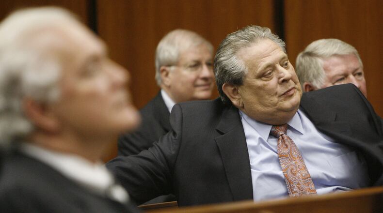 Dwight Brown, in salmon-colored tie, sits in court in this 2009 photo listening to the a case related to the scandal over financial dealings during his tenure as head of Cobb EMC. BOB ANDRES / bandres@ajc.com