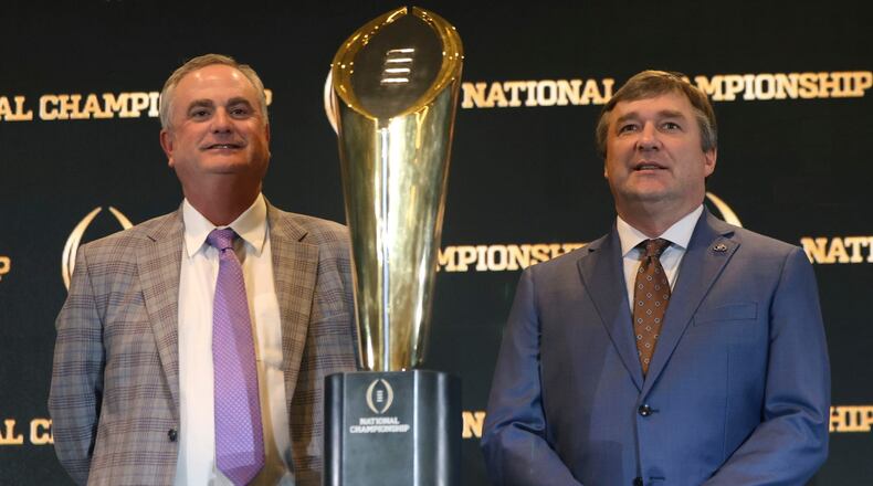TCU coach Sonny Dykes and Georgia coach Kirby Smart pose with the championship trophy before the 2023 title game earlier this year. This will be the final season of the four-team playoff format, and 12 teams will begin playing for the title beginning next year.
