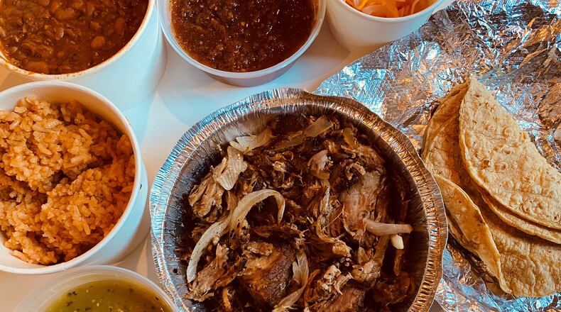 The carnitas dinner for two from Taqueria el Tesoro includes twice-cooked pork carnitas, choice of beans, rice, tortillas, and chips and salsa. Bob Townsend for The AJC