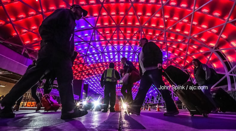 The north canopy at Hartsfield-Jackson International Airport lights up to welcome visitors to Atlanta for the Super Bowl. After some early showers, Atlanta is expected to be dry and warm Sunday afternoon, according to Channel 2 Action News.