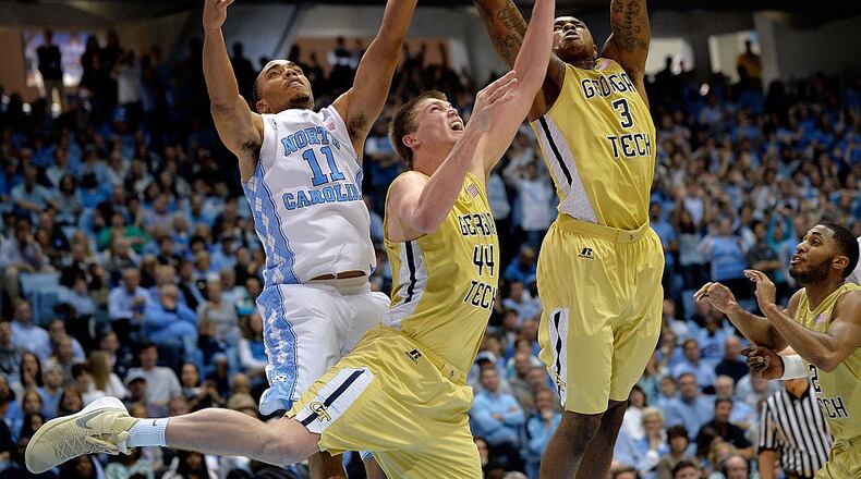 CHAPEL HILL, NC - JANUARY 02: Brice Johnson #11 of the North Carolina Tar Heels battles Ben Lammers #44 and Marcus Georges-Hunt #3 of the Georgia Tech Yellow Jackets for a rebound during their game at the Dean Smith Center on January 2, 2016 in Chapel Hill, North Carolina. North Carolina won 86-78. (Photo by Grant Halverson/Getty Images)