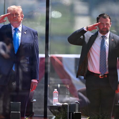 President Donald Trump, left, and Secretary of Homeland Security Markwayne Mullin, right, saluting at the start of the commencement ceremony at the U.S. Coast Guard Academy in New London, Conn., Wednesday, May 20, 2026. (AP Photo/Jessica Hill)