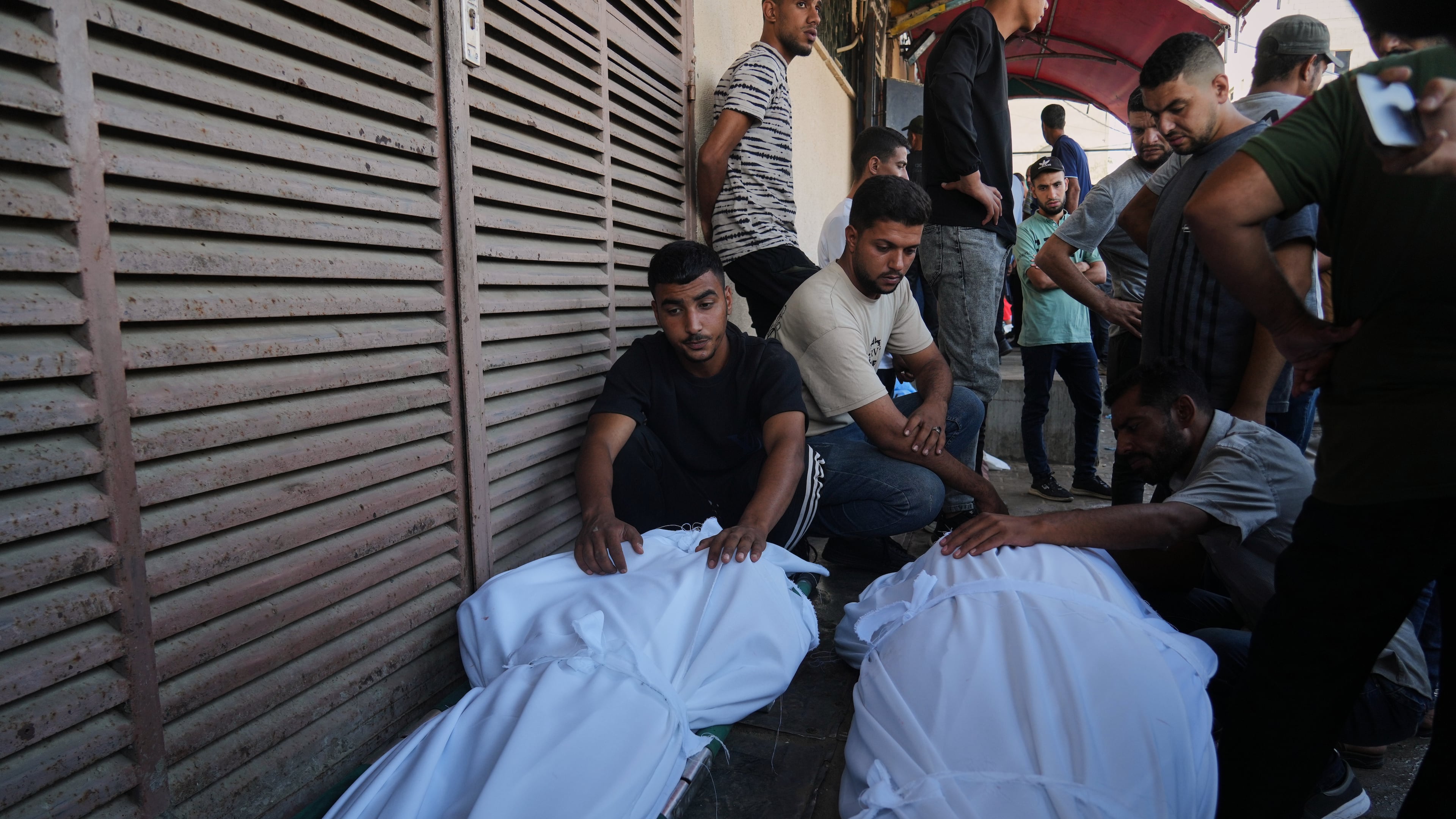 Mourners attend the funeral of Palestinians killed in an Israeli army strike, outside Al-Aqsa Hospital in Deir al-Balah, central Gaza Strip, Saturday, Oct. 4, 2025. (AP Photo/Abdel Kareem Hana)