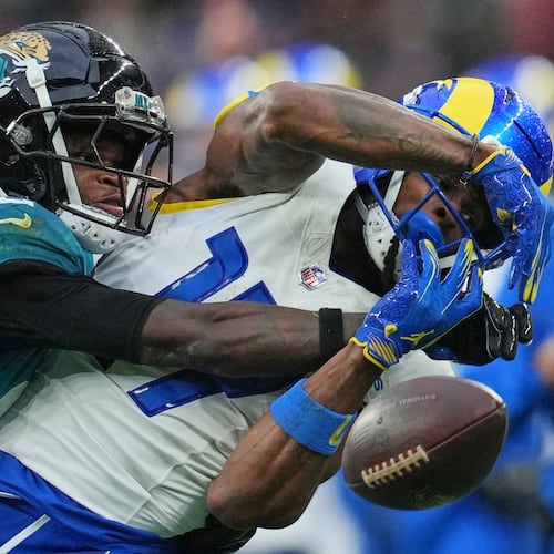 Los Angeles Rams wide receiver Davante Adams (17) is challenged by Jacksonville Jaguars wide receiver Travis Hunter (12) during the second half of an NFL football game between the Los Angeles Rams and the Jacksonville Jaguars in London, Sunday, Oct. 19, 2025. (AP Photo/Kin Cheung)