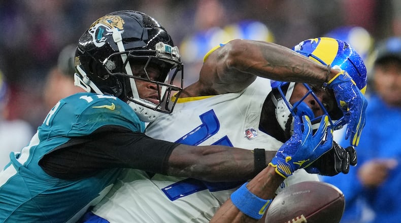 Los Angeles Rams wide receiver Davante Adams (17) is challenged by Jacksonville Jaguars wide receiver Travis Hunter (12) during the second half of an NFL football game between the Los Angeles Rams and the Jacksonville Jaguars in London, Sunday, Oct. 19, 2025. (AP Photo/Kin Cheung)
