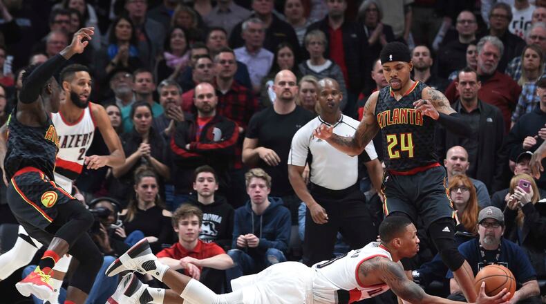Portland Trail Blazers guard Damian Lillard falls to the court as he drives to the basket during overtime of an NBA basketball game against the Atlanta Hawksin Portland, Ore., Monday, Feb 13, 2017. Atlanta won in overtime 109-104. (AP Photo/Steve Dykes)