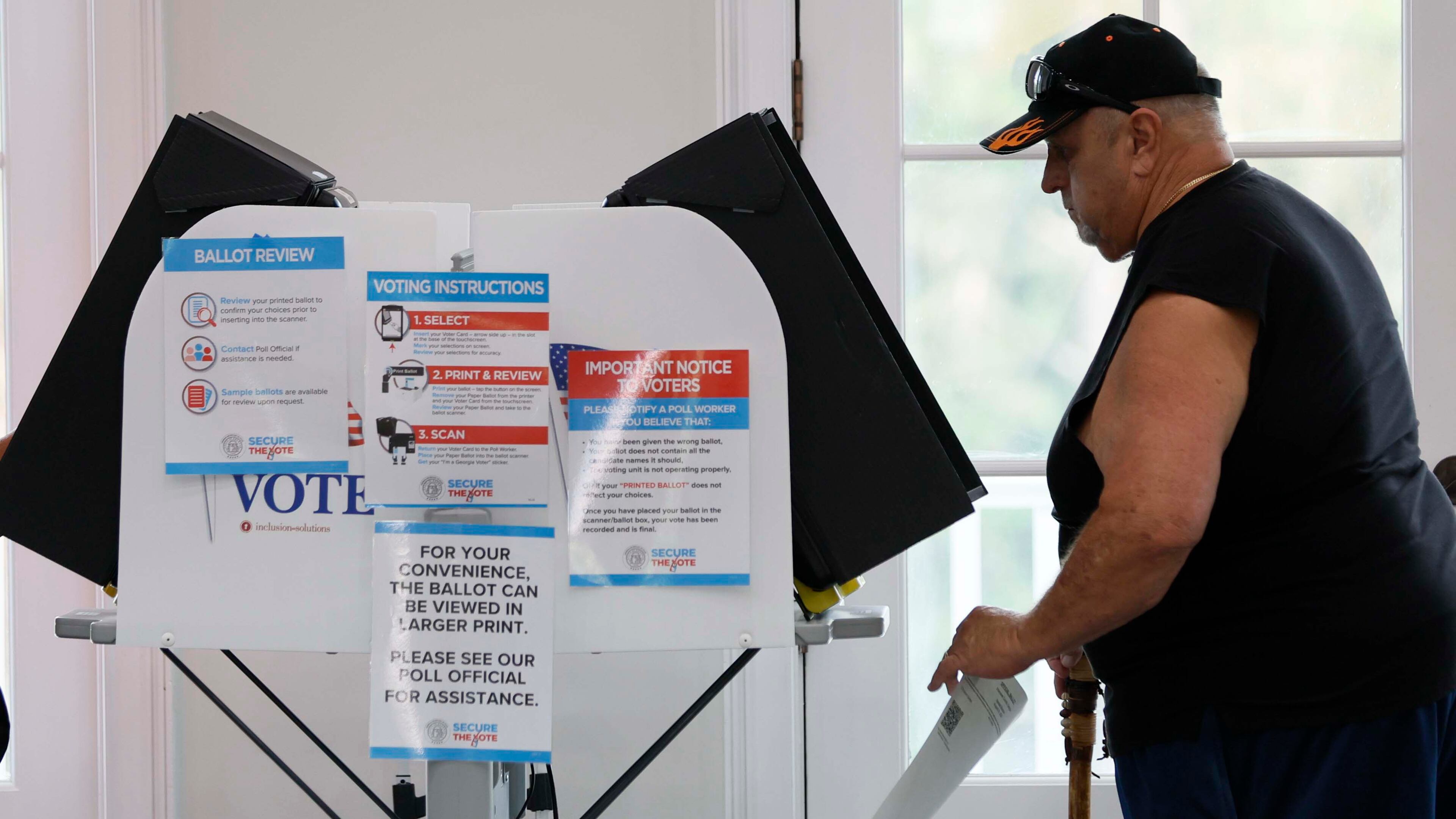 David Palyok takes his ballot at the River-Green subdivision on Tuesday, Aug. 26, 2025, in Canton. The off-year special election for the state Senate seat is to fill the remainder of former state Sen. Brandon Beach’s term, which runs through January 2027. (Miguel Martinez/AJC)