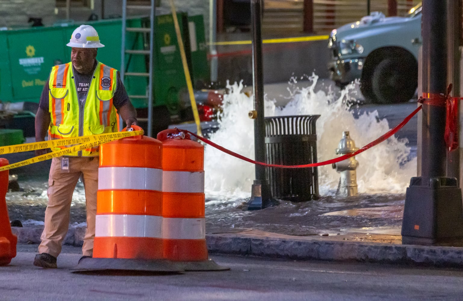 Crews are continuing to work on a broken main on West Peachtree Street at 11th Street in Midtown, with nearby residents warned of impacts to their water service as the crisis reached its fourth day Monday, June 3, 2024. Water had been gushing out of the broken main until Monday morning, when workers were seen pumping out water. (John Spink/AJC)
