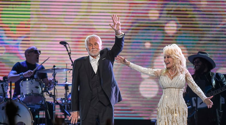 Kenny Rogers and Dolly Parton wave goodbye to the crowd after performing for the last time at the "All In For the Gambler" tribute to Rogers at Bridgestone Arena in Nashville on Oct. 25, 2017.