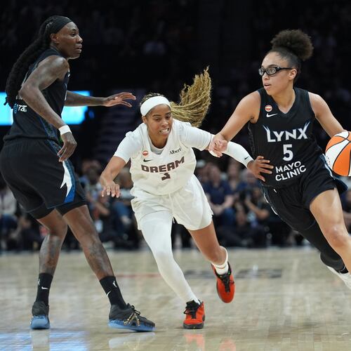 Minnesota Lynx guard Olivia Miles (5) works toward the basket while defended by Atlanta Dream guard Jordin Canada (3) during the first half of a WNBA basketball game Wednesday, May 27, 2026, in Minneapolis. (AP Photo/Abbie Parr)