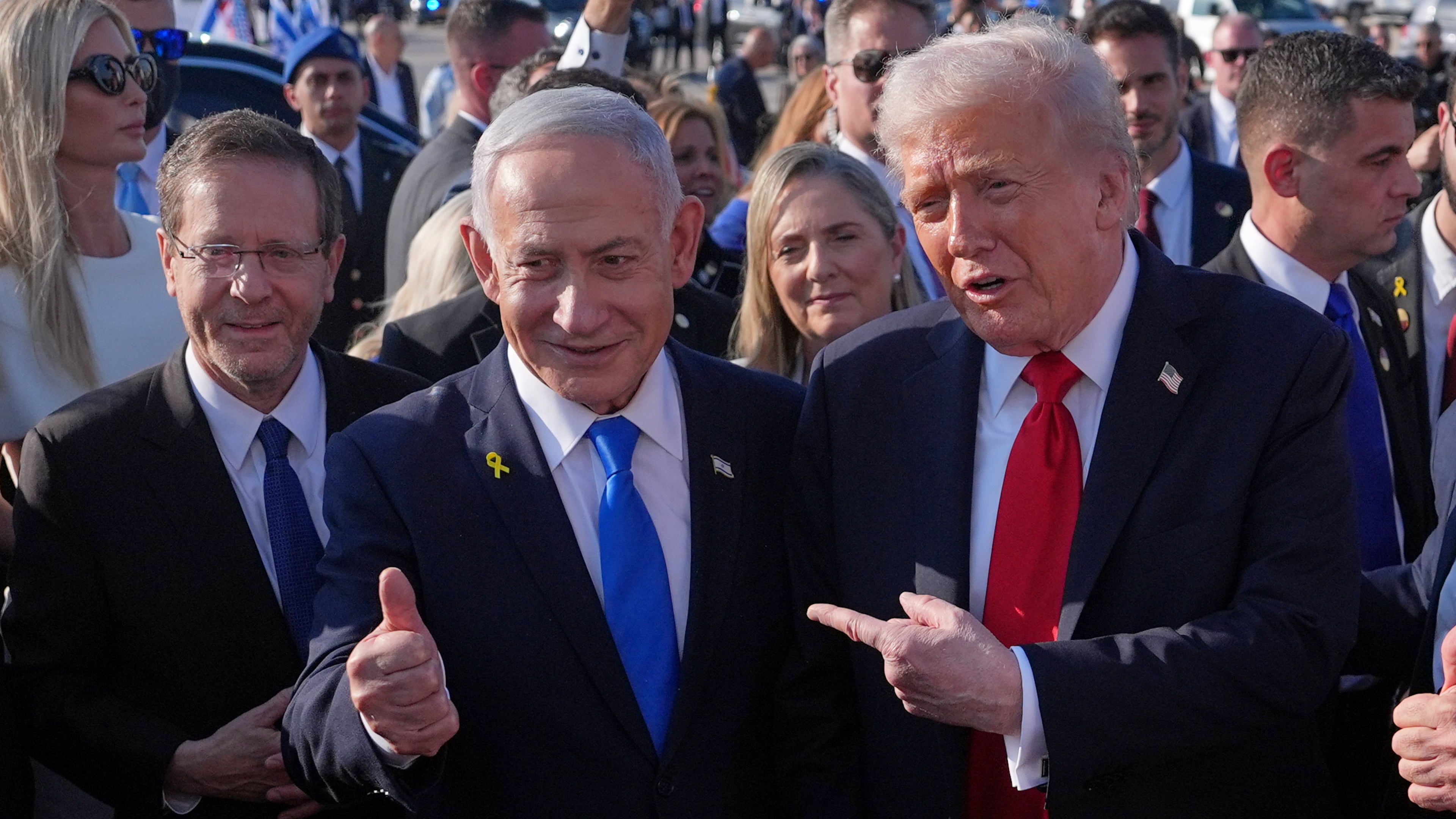 President Donald Trump poses for a photo with Israel's Prime Minister Benjamin Netanyahu before he boards Air Force One at Ben Gurion International Airport, Monday, Oct. 13, 2025, near Tel Aviv, as Israel's President Isaac Herzog watches at left. (AP Photo/Evan Vucci)