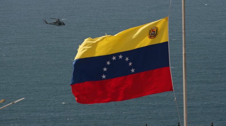 A helicopter takes off from a U.S. Navy ship docked at the seaport to support earthquake relief efforts in La Guaira, Venezuela, Monday, June 29, 2026. (AP Photo/Matias Delacroix)