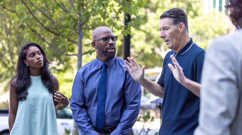 (L-R) Tiara Sinkfield, director of state programs for Cardiac Arrest Registry to Enhance Survival (CARES); Willie Hatchett, a cardiac arrest survivor; and Gary Blissett, ambassador for Brentford Football Club; appear in a press conference at Emory University Hospital in Atlanta on Wednesday, July 26, 2023. Emory teamed up with with Brentford Football Club to promote the importance of an emergency response plan in athletics. (Arvin Temkar / arvin.temkar@ajc.com)