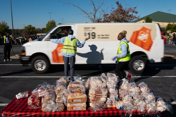 Volunteers direct traffic during a food giveaway at New Birth Missionary Baptist Church on Saturday, Nov. 1, 2025, in Stonecrest. (Ben Gray for the AJC)