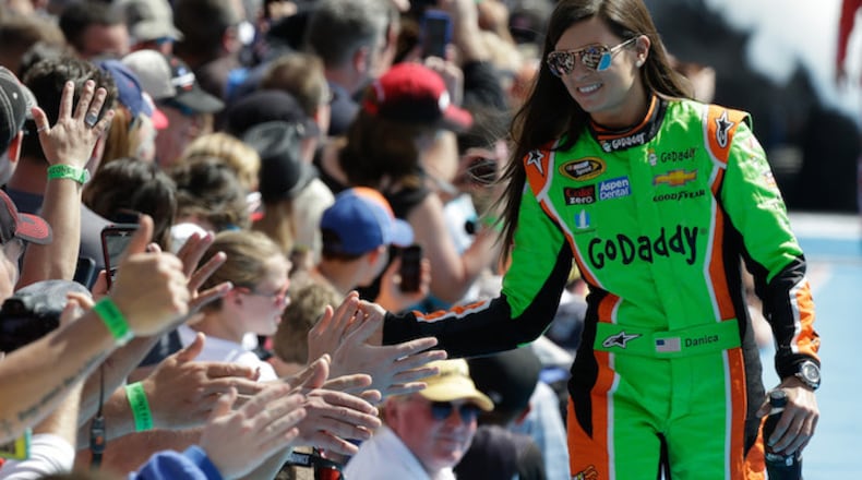 Danica Patrick greets fans as she is introduced before the start of the Daytona 500 NASCAR Sprint Cup series auto race at Daytona International Speedway in Daytona Beach, Fla., Sunday, Feb. 22, 2015. (AP Photo/John Raoux)