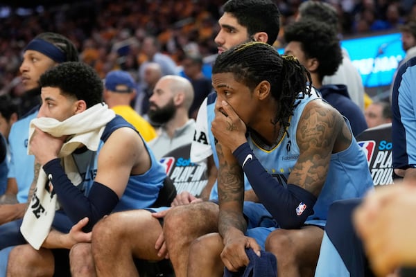 Memphis Grizzlies guard Ja Morant, right, reacts from the bench during the second half of an NBA play-in tournament basketball game against the Golden State Warriors in San Francisco, Tuesday, April 15, 2025. (AP Photo/Jeff Chiu)