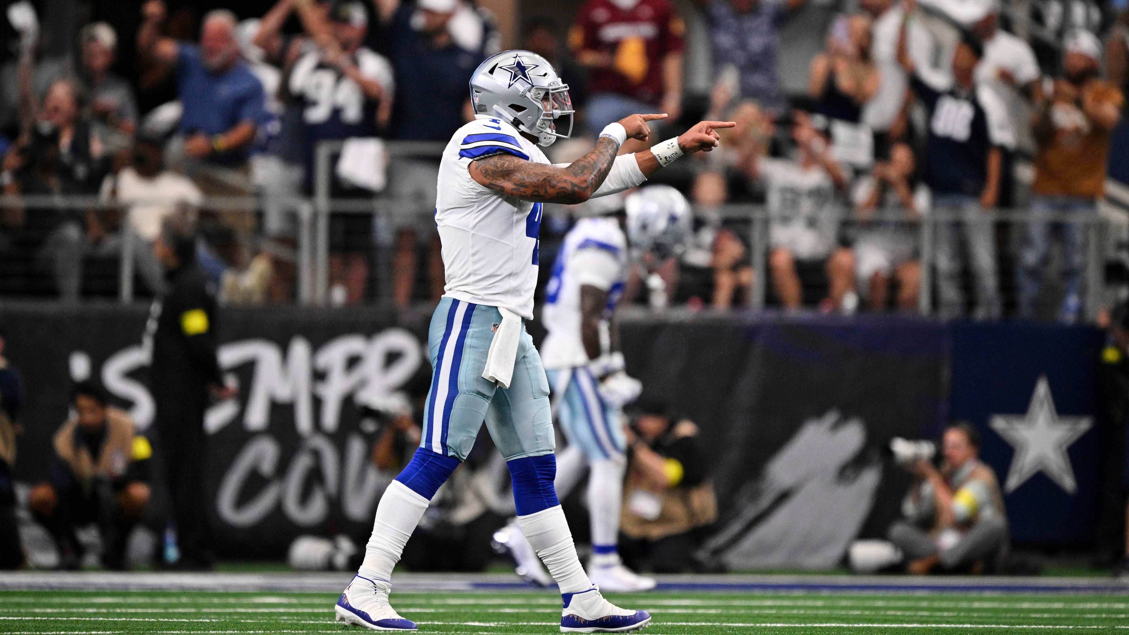 Dallas Cowboys quarterback Dak Prescott (4) celebrates a touchdown late in the second half of an NFL football game against the New York Giants Sunday, Sept. 14, 2025, in Arlington, Texas. (AP Photo/Jerome Miron)