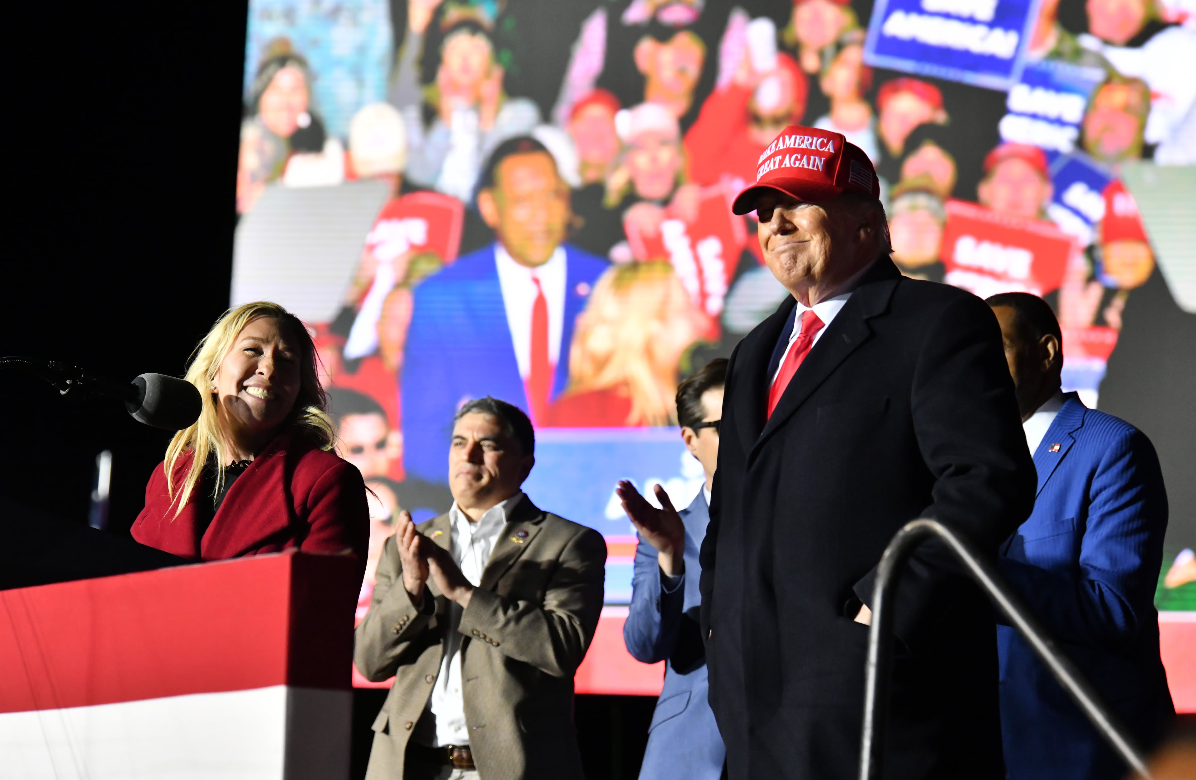 U.S. Rep. Marjorie Taylor Greene (left) and Donald Trump (right) during happier times at an event in Commerce in 2022.
