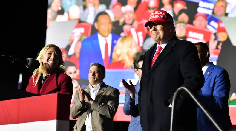 March 26, 2022 Commerce - U.S. Rep. Marjorie Taylor Greene thanks to former President Donald Trump during a rally for Georgia GOP candidates at Banks County Dragway in Commerce on Saturday, March 26, 2022. (Hyosub Shin / Hyosub.Shin@ajc.com)