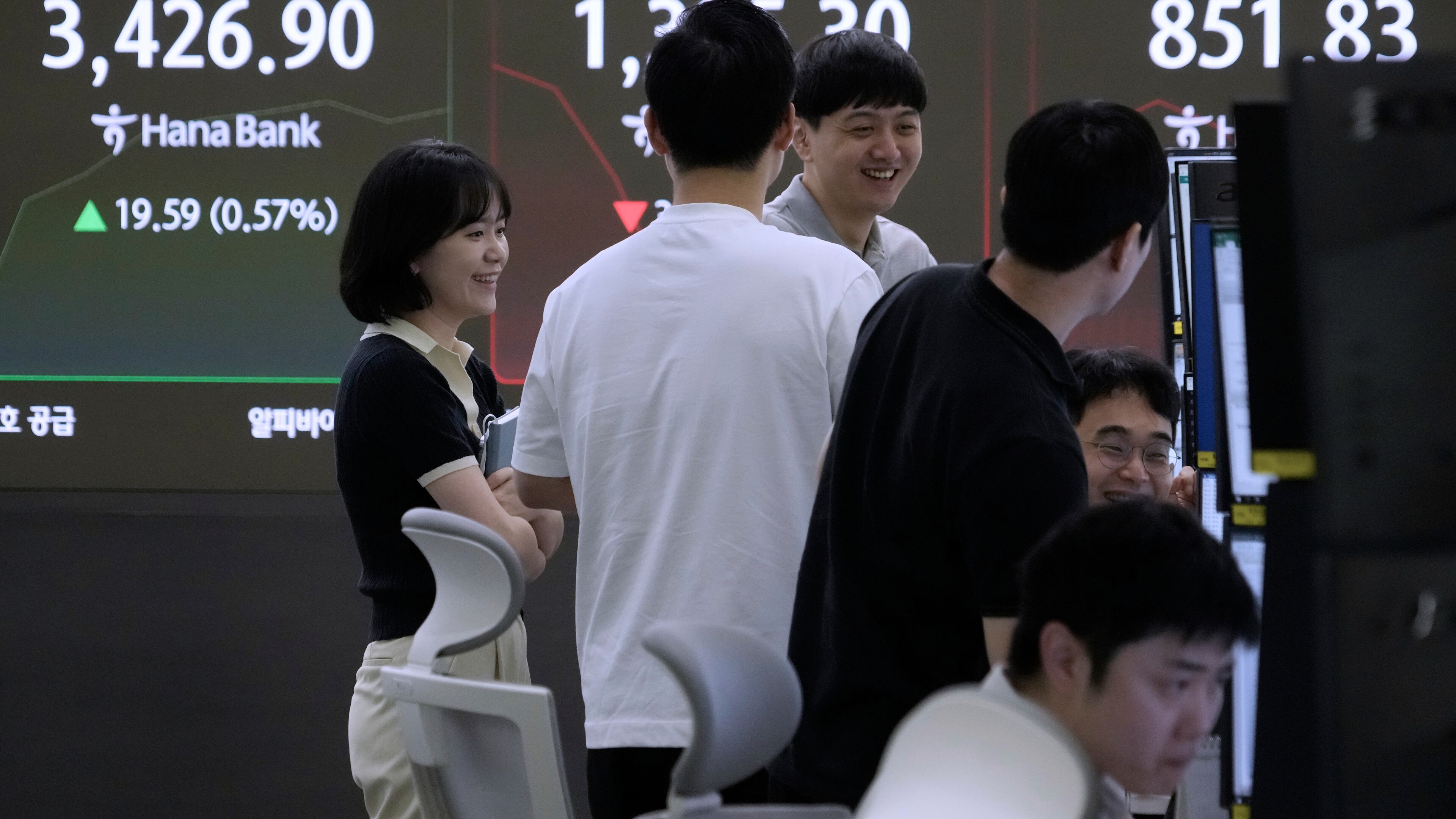 Currency traders work near a screen showing the Korea Composite Stock Price Index (KOSPI), top left, at the foreign exchange dealing room of the Hana Bank headquarters in Seoul, South Korea, Tuesday, Sept. 16, 2025. (AP Photo/Ahn Young-joon)