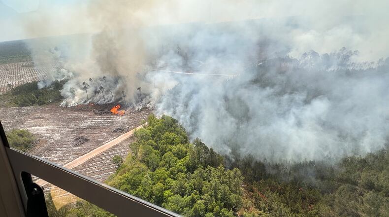The photo provided by the Office of Gov. Brian Kemp shows smoke produced from a wildfire in Brantley County, Ga., Friday, April 24, 2026. (Office of Gov. Brian Kemp via AP)