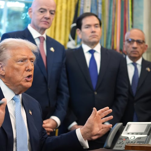 President Donald Trump answers questions from reporters during a meeting with the White House task force on the 2026 FIFA World Cup in the Oval Office of the White House, Monday, Nov. 17, 2025, in Washington, as FIFA President Gianni Infantino, Secretary of State Marco Rubio and FIFA senior adviser Carlos Cordeiro listen. (AP Photo/Evan Vucci)