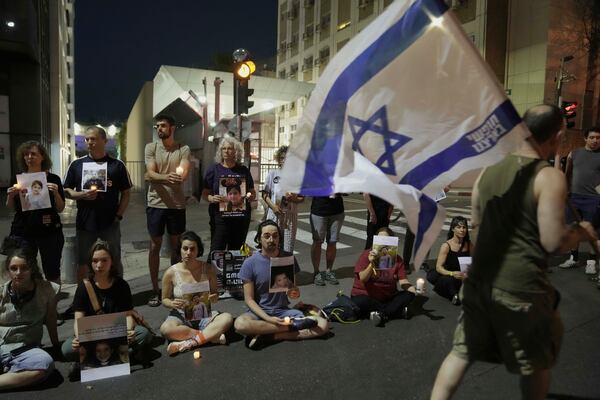 Protesters hold pictures of Palestinian children killed during Israel's military operation in the Gaza Strip in a protest demanding the end of the war, in Tel Aviv, Israel, Saturday, May 17, 2025. (AP Photo/Maya Alleruzzo)