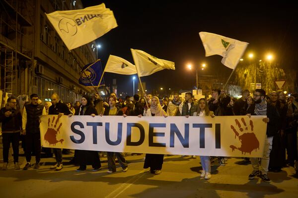 Students carry a banner reading "Students" in Serbian Latin alphabet during an anti-corruption protest in the southwestern town of Novi Pazar, Serbia, Friday, April 11, 2025. (AP Photo/Marko Drobnjakovic)