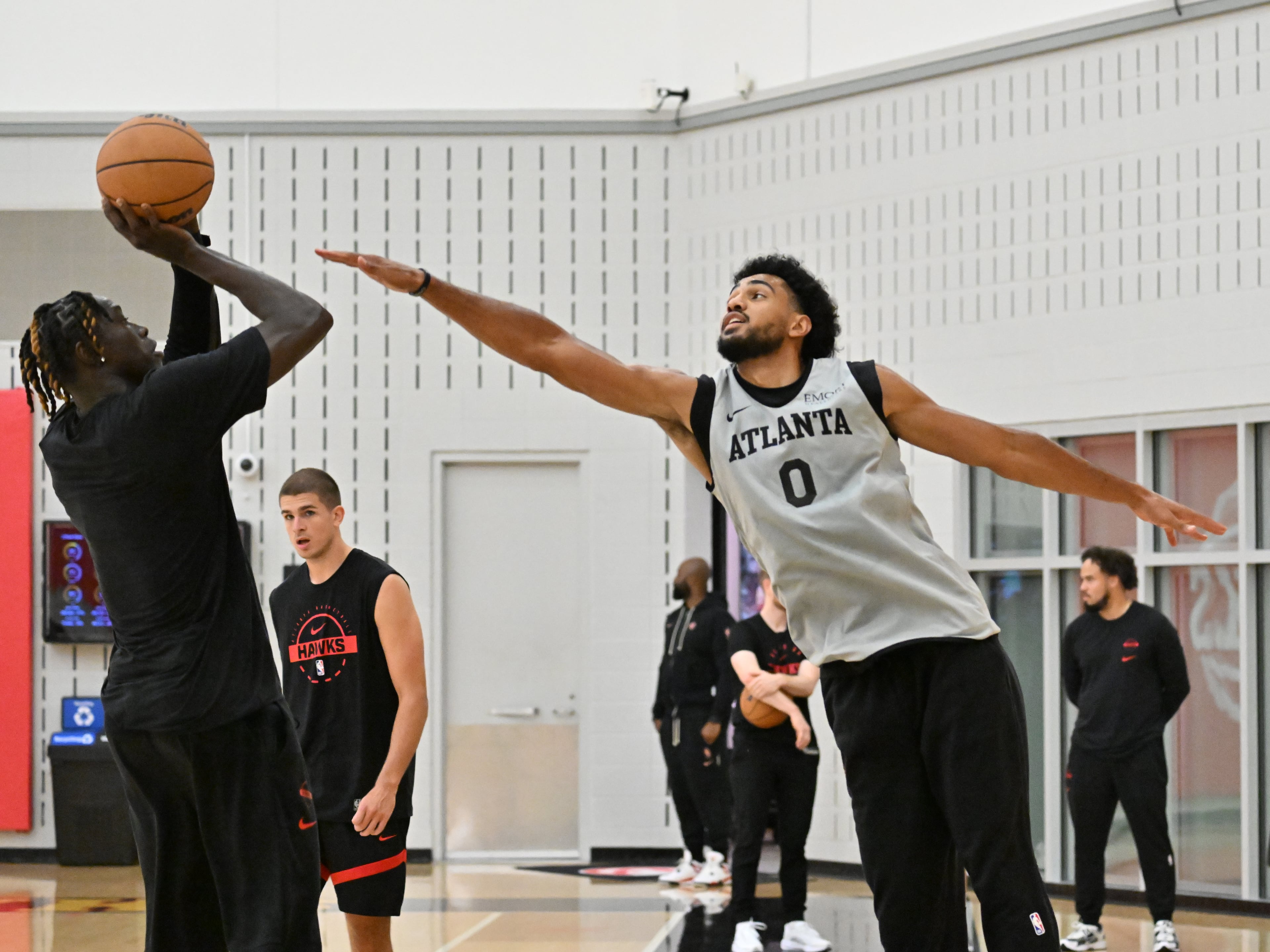Hawks forward Jacob Toppin (right) runs a drill during the first day of training camp at the team’s practice facility inside the Emory Sports Medicine Complex on Tuesday, Sept. 30, 2025, in Brookhaven. (Hyosub Shin/AJC)