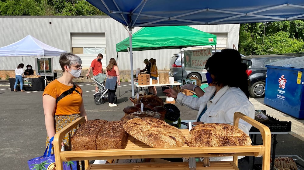 A customer places an order at Osono Bread, which pops up at Grant Park Farmers Market on Sundays. Wendell Brock for The Atlanta Journal-Constitution