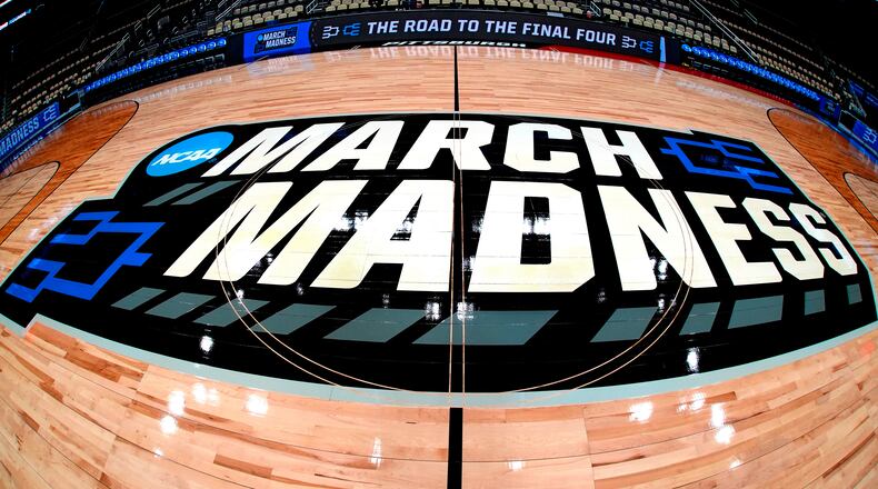 FILE - March Madness logo sis displayed at center court during the opening rounds of the NCAA college basketball tournament in Pittsburgh, Wednesday, March 20, 2024. (AP Photo/Gene J. Puskar, File)