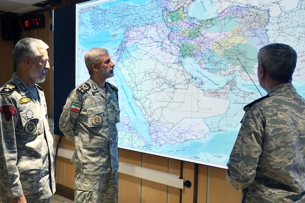 In this photo released on Monday, 23, 2025, by Iranian army press service, Iran's army commander-in-chief Gen. Amir Hatami, center, Admiral Mahmoud Mousavi, right, and Admiral Habibollah Sayyari attend a meeting in Zolfaghar central headquarters, Iran. (Iranian Army Press Service via AP)