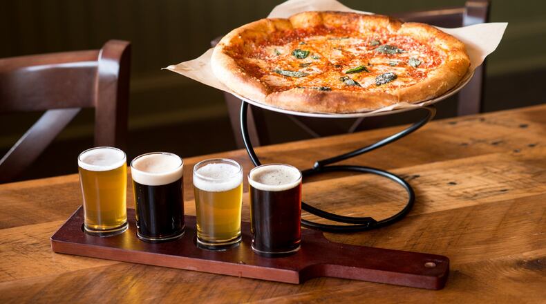 ity Tap Classic Margherita pizza with tomato sauce, fresh mozzarella, extra virgin olive oil, and basil, with a flight of beer. Photo credit- Mia Yakel.