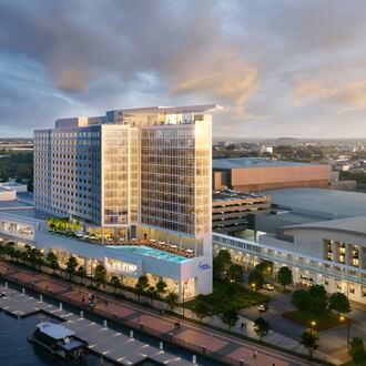 A rendering of a large, modern hotel at golden hour on Hutchison Island next to the Savannah Convention Center.
