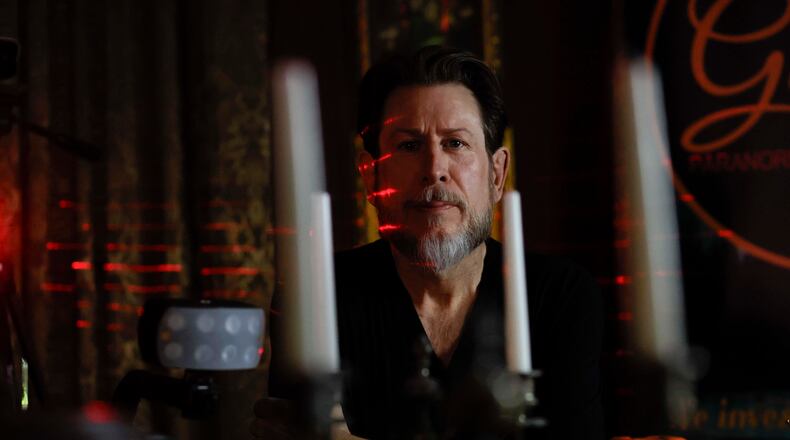 Paranormal investigator Philip Wyatt posed for a photograph in his home on Tuesday, Oct. 13, 2025. He has been investigating paranormal events for 15 years, a pursuit that began after personal experiences sparked his interest. (Miguel Martinez/AJC)