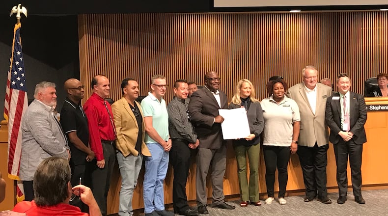 Gwinnett Commissioner Ben Ku (far right) and representatives from Positive Impact Health Center and the Norcross Gay Club pose for a photo following  a proclamation declaring June 2019 as pride month in Gwinnett County. TYLER ESTEP / TYLER.ESTEP@AJC.COM