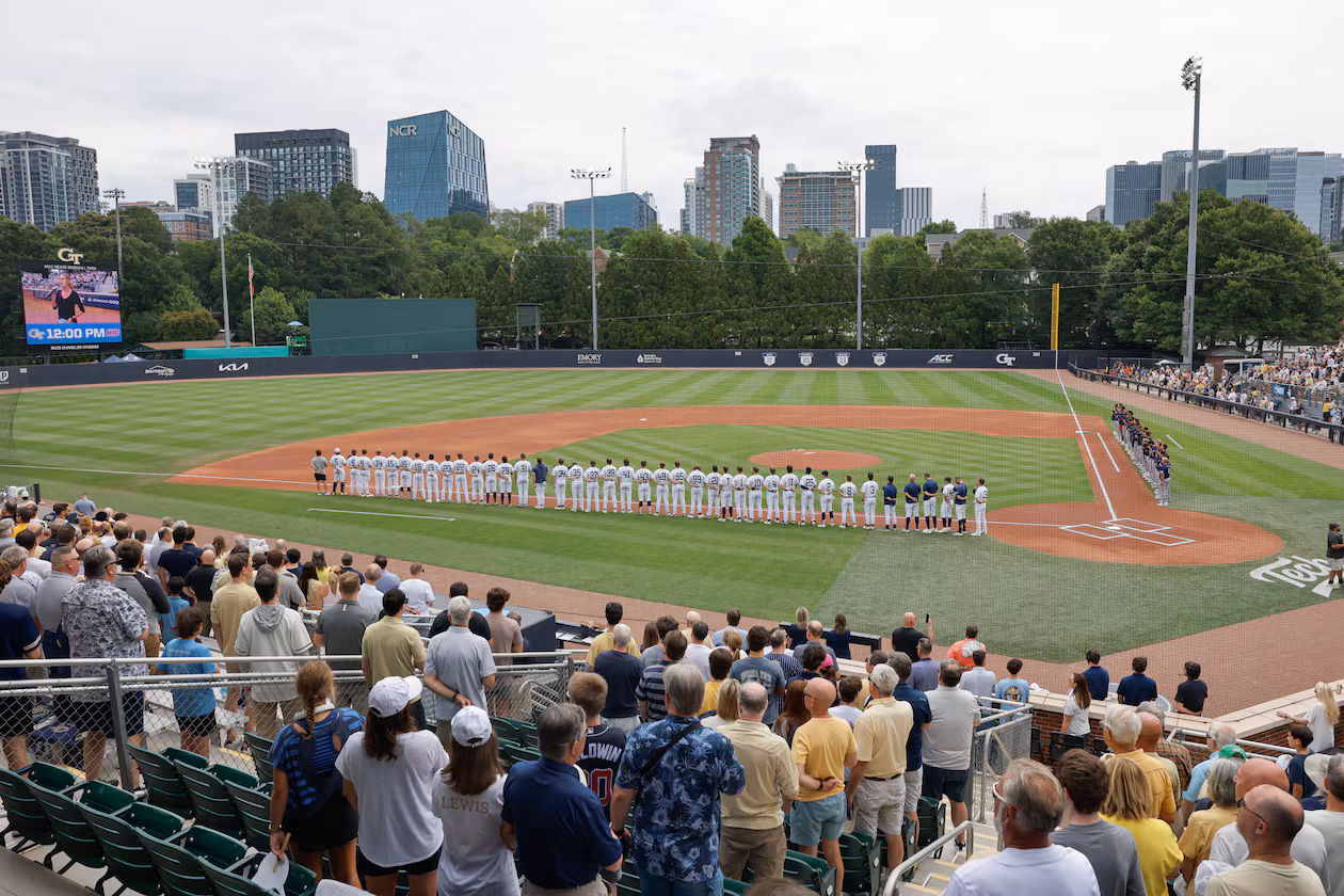 Georgia Tech players (left), Illinois Chicago players and fans stand for the national anthem before the start of their Atlanta Regional at Russ Chandler Stadium on Friday, May 29, 2026, in Atlanta. (Erik S. Lesser for the AJC)