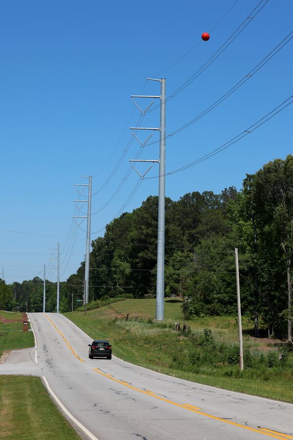 Graves Road in Fayetteville has 230kV high-voltage transmission lines beside it. These power lines have been installed within the past year, according to Rachael Maszk, who says this is an example of what Georgia Power wants to install in her backyard. (Jason Getz/AJC)