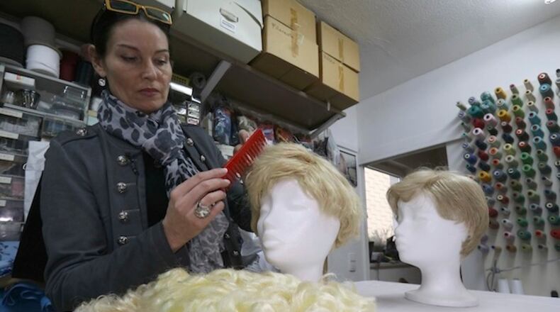 Manuela Plank ownerof a costume rental shop fashioning normal blond hairpieces into Trump wigs in Pfaffstaetten, Austria, Monday, Feb. 20, 2017. (AP Photo/Ronald Zak)