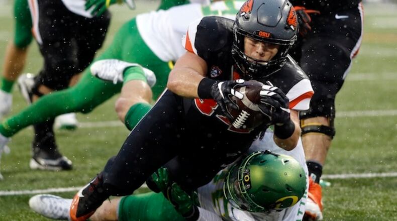 Oregon State running back Ryan Nall, top, dives over Oregon's Danny Mattingly for a touchdown in the second half an NCAA college football game in Corvallis, Ore., Saturday Nov. 26, 2016. Oregon State won 34-24. (AP Photo/Timothy J. Gonzalez)