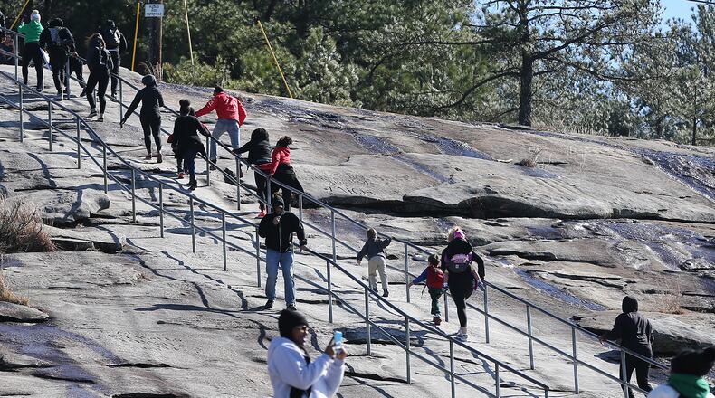 Participants scale a steep section of the trail while commemorating the life of Dr. Martin Luther King, Jr., by climbing to the top of Stone Mountain with children who aspire to be great during "The Dream Walk" on Sunday, Jan. 17, 2016, in Stone Mountain. In his "I Have A Dream" speech, Dr. King spoke of a symbolic bell of freedom ringing from the tops of Stone Mountain to the hills of Tennessee. Curtis Compton / ccompton@ajc.com
